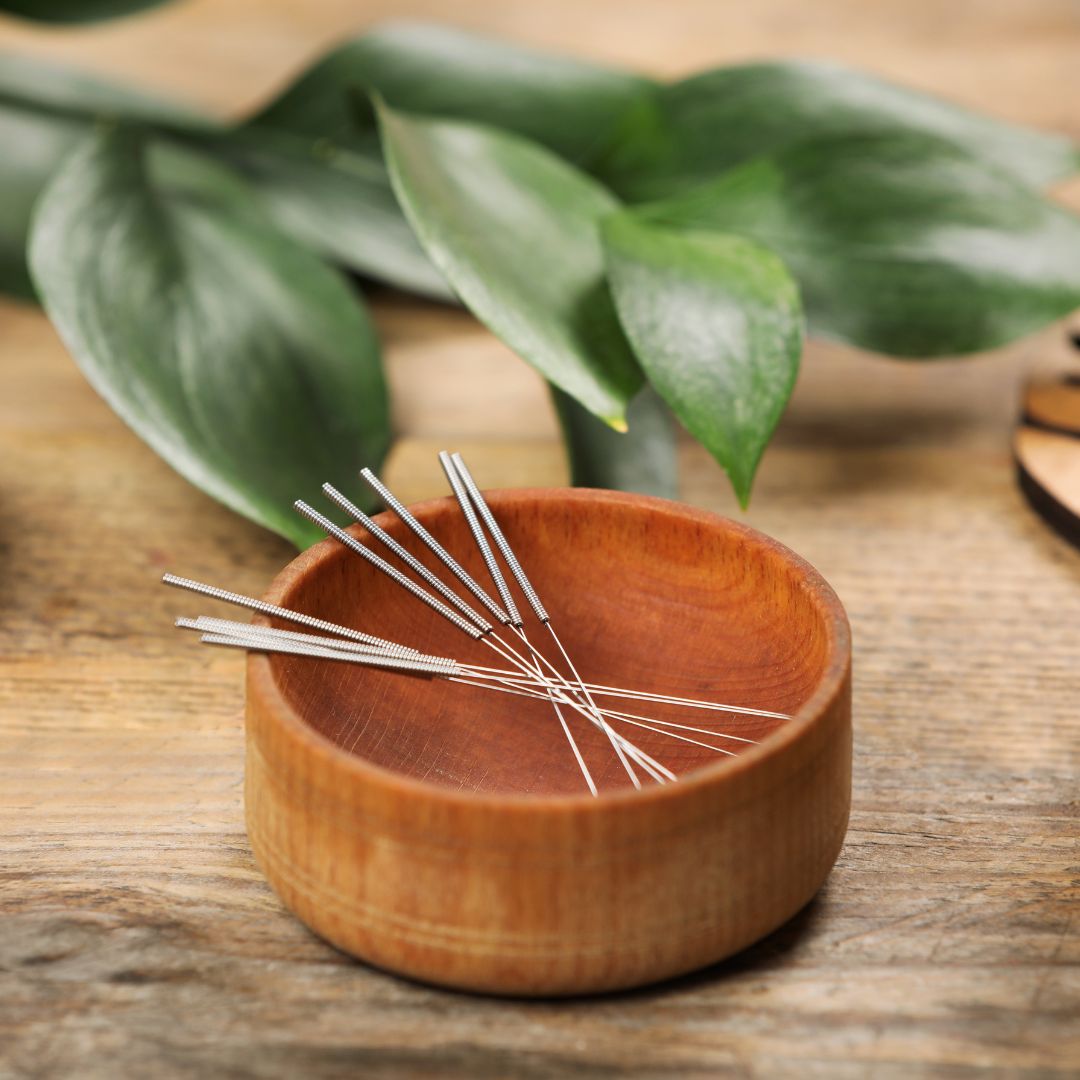 Acupuncture needles in a wooden bowl. 